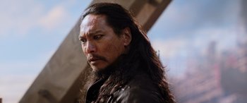 Movie still from “Mulan” (2020), directed by Niki Caro – A person with long black hair; Close Up shot, Low angle