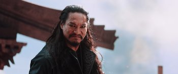 Movie still from “Mulan” (2020), directed by Niki Caro – A person with long black hair; Close Up shot, Low angle