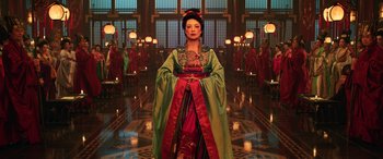 Movie still from “Mulan” (2020), directed by Niki Caro – A woman dressed in oriental clothing standing in front of a group of people; Medium shot, Low angle