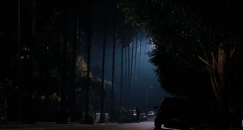 Movie still from “Mulholland Drive” (2001), directed by David Lynch – A car is parked on the side of the road at night; Extreme Wide shot, Low angle