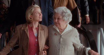 Movie still from “Mulholland Drive” (2001), directed by David Lynch – Two women standing next to each other and smiling; Medium shot, Over the shoulder angle
