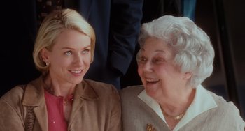 Movie still from “Mulholland Drive” (2001), directed by David Lynch – A woman and an older woman smiling for the camera; Close Up shot, Over the shoulder angle