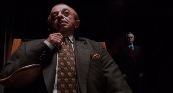 Movie still from “Mulholland Drive” (2001), directed by David Lynch – An older man wearing a suit and tie; Close Up shot, Low angle