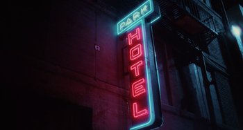 Movie still from “Mulholland Drive” (2001), directed by David Lynch – A neon sign that reads " park hotel " on the side of a building; Wide shot, Low angle