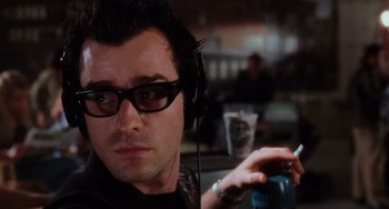Movie still from “Mulholland Drive” (2001), directed by David Lynch – A man wearing headphones and a black shirt is looking at the camera; Close Up shot, Low angle