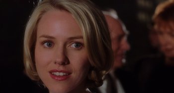 Movie still from “Mulholland Drive” (2001), directed by David Lynch – A woman's face with a man in the background; Close Up shot, Over the shoulder angle