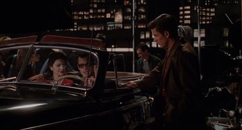 Movie still from “Mulholland Drive” (2001), directed by David Lynch – A group of people sitting in the back of a car; Medium shot, Over the shoulder angle