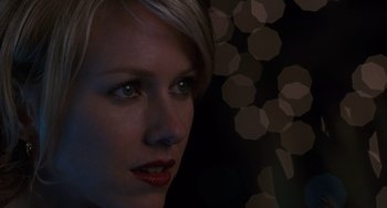 Movie still from “Mulholland Drive” (2001), directed by David Lynch – A person wearing a black shirt; Close Up shot, Over the shoulder angle