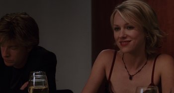 Movie still from “Mulholland Drive” (2001), directed by David Lynch – A woman sitting at a table with a glass of wine; Close Up shot, Over the shoulder angle