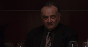 Movie still from “Mulholland Drive” (2001), directed by David Lynch – An older man wearing a suit and tie; Close Up shot, Low angle