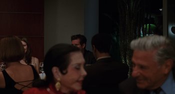 A group of people are gathered around a table at a party