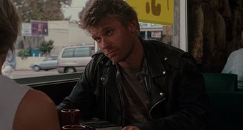 Movie still from “Mulholland Drive” (2001), directed by David Lynch – A man sitting at a table with a cup of coffee in front of him; Close Up shot, Over the shoulder angle