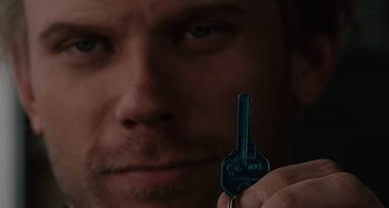 Movie still from “Mulholland Drive” (2001), directed by David Lynch – A person holding a key; Extreme Close Up shot, Overhead angle