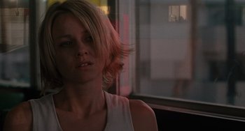 Movie still from “Mulholland Drive” (2001), directed by David Lynch – A beautiful young woman with blonde hair standing in front of a window; Close Up shot, Over the shoulder angle