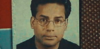 Movie still from “Mumbai Mafia: Police vs the Underworld” (2023), directed by Raaghav Dar – A man with glasses and a black shirt; Extreme Close Up shot, High angle