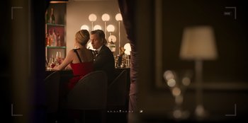 Movie still from “Murder Mystery 2” (2023), directed by Jeremy Garelick – A man and a woman are sitting at a table; Medium shot, Over the shoulder angle