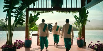 Movie still from “Murder Mystery 2” (2023), directed by Jeremy Garelick – A group of men walking across a bridge; Wide shot, Low angle