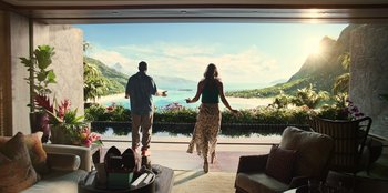 Movie still from “Murder Mystery 2” (2023), directed by Jeremy Garelick – A man and a woman standing in front of an open window; Wide shot, Over the shoulder angle