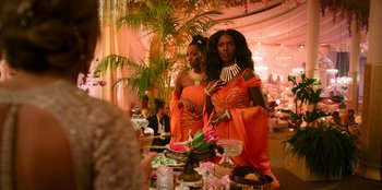 Movie still from “Murder Mystery 2” (2023), directed by Jeremy Garelick – A couple of women standing next to each other; Medium shot, Over the shoulder angle