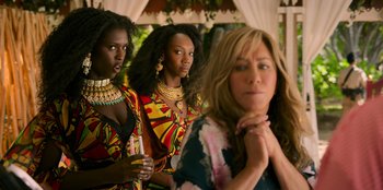 Movie still from “Murder Mystery 2” (2023), directed by Jeremy Garelick – A group of women standing next to each other; Medium shot, Over the shoulder angle