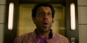 Movie still from “Murder Mystery 2” (2023), directed by Jeremy Garelick – A person wearing a purple shirt; Close Up shot, Overhead angle