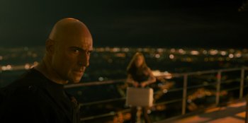 Movie still from “Murder Mystery 2” (2023), directed by Jeremy Garelick – A man and a woman standing next to a railing at night; Close Up shot, Low angle