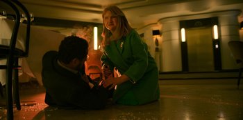 Movie still from “Murder Mystery 2” (2023), directed by Jeremy Garelick – A man and a woman sitting on the ground; Medium shot, High angle