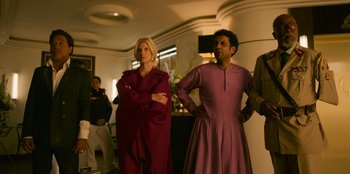 Movie still from “Murder Mystery 2” (2023), directed by Jeremy Garelick – A woman and a man standing next to each other in a room; Medium shot, Low angle