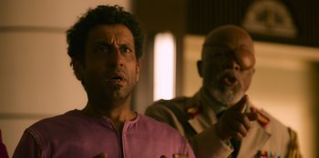 Movie still from “Murder Mystery 2” (2023), directed by Jeremy Garelick – A man and an older man standing next to each other; Close Up shot, Over the shoulder angle