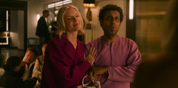 Movie still from “Murder Mystery 2” (2023), directed by Jeremy Garelick – A man and a woman standing next to each other; Medium shot, Over the shoulder angle