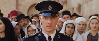 Movie still from “Murder on the Orient Express” (2017), directed by Kenneth Branagh – A person wearing a uniform; Close Up shot, Low angle