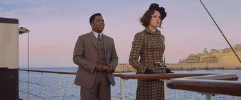 Movie still from “Murder on the Orient Express” (2017), directed by Kenneth Branagh – A man and a woman standing next to each other on a boat; Medium shot, Low angle