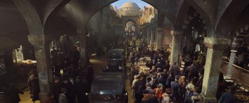 Movie still from “Murder on the Orient Express” (2017), directed by Kenneth Branagh – A crowd of people walking through an alley way; Extreme Wide shot, High angle