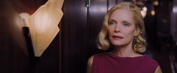 Movie still from “Murder on the Orient Express” (2017), directed by Kenneth Branagh – A woman with blonde hair wearing a purple dress; Close Up shot, Low angle