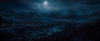 Movie still from “Murder on the Orient Express” (2017), directed by Kenneth Branagh – A view of a mountain range with a full moon in the background; Extreme Wide shot, High angle