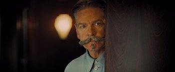 Movie still from “Murder on the Orient Express” (2017), directed by Kenneth Branagh – A man with a long mustache and a beard; Close Up shot, Low angle