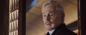 Movie still from “Murder on the Orient Express” (2017), directed by Kenneth Branagh – An older man with a mustache and a mustache comb; Close Up shot, Over the shoulder angle