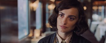 Movie still from “Murder on the Orient Express” (2017), directed by Kenneth Branagh – A person wearing a suit and tie; Close Up shot, Over the shoulder angle