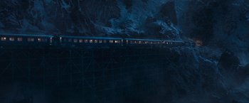 Movie still from “Murder on the Orient Express” (2017), directed by Kenneth Branagh – A train traveling on a bridge in the dark; Extreme Wide shot, High angle