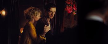 Movie still from “Murder on the Orient Express” (2017), directed by Kenneth Branagh – A man and a woman standing next to each other in a room; Medium shot, Low angle