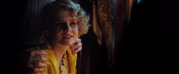 Movie still from “Murder on the Orient Express” (2017), directed by Kenneth Branagh – A woman with blonde hair and a yellow scarf; Close Up shot, Low angle