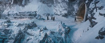 Movie still from “Murder on the Orient Express” (2017), directed by Kenneth Branagh – A group of people standing on top of a snow covered slope; Extreme Wide shot, High angle