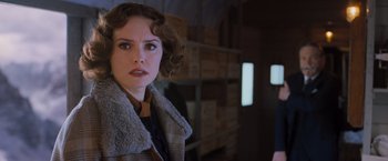 Movie still from “Murder on the Orient Express” (2017), directed by Kenneth Branagh – A person wearing a coat; Close Up shot, Over the shoulder angle