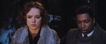 Movie still from “Murder on the Orient Express” (2017), directed by Kenneth Branagh – A person wearing a jacket; Close Up shot, Over the shoulder angle