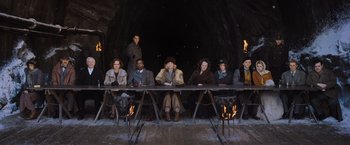 Movie still from “Murder on the Orient Express” (2017), directed by Kenneth Branagh – A group of people sitting around a table; Wide shot, High angle