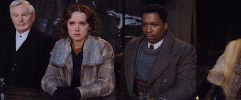 Movie still from “Murder on the Orient Express” (2017), directed by Kenneth Branagh – A man and a woman sitting next to each other; Medium shot, Over the shoulder angle