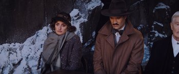 Movie still from “Murder on the Orient Express” (2017), directed by Kenneth Branagh – A man and a woman wearing coats and hats; Medium shot, Over the shoulder angle