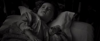 Movie still from “Murder on the Orient Express” (2017), directed by Kenneth Branagh – A little girl is sleeping with a teddy bear in her arms; Close Up shot, High angle