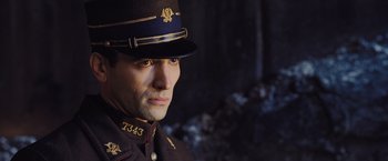 Movie still from “Murder on the Orient Express” (2017), directed by Kenneth Branagh – A person wearing a uniform; Close Up shot, High angle