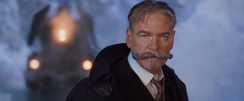Movie still from “Murder on the Orient Express” (2017), directed by Kenneth Branagh – An older man with a mustache and a beard; Close Up shot, Low angle